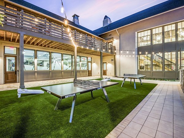 Spacious recreational area featuring lush landscaping at Vecina Apartment Villas