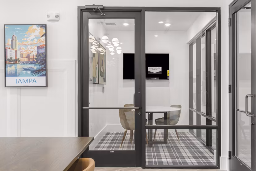 Meeting space with modern amenities at clubhouse in Marlowe South Tampa Apartments, featuring a sleek design ideal for gatherings and events