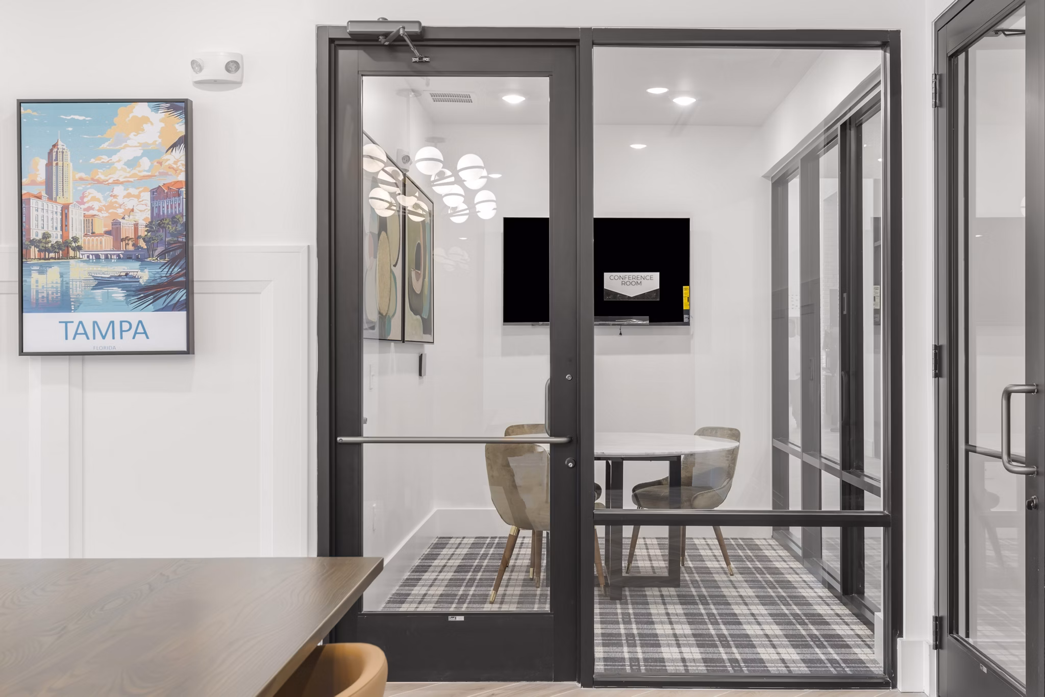 Meeting space with modern amenities at clubhouse in Marlowe South Tampa Apartments, featuring a sleek design ideal for gatherings and events