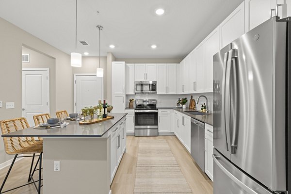 Contemporary kitchen featuring stainless steel appliances and granite countertops at Marlowe South Tampa Apartments