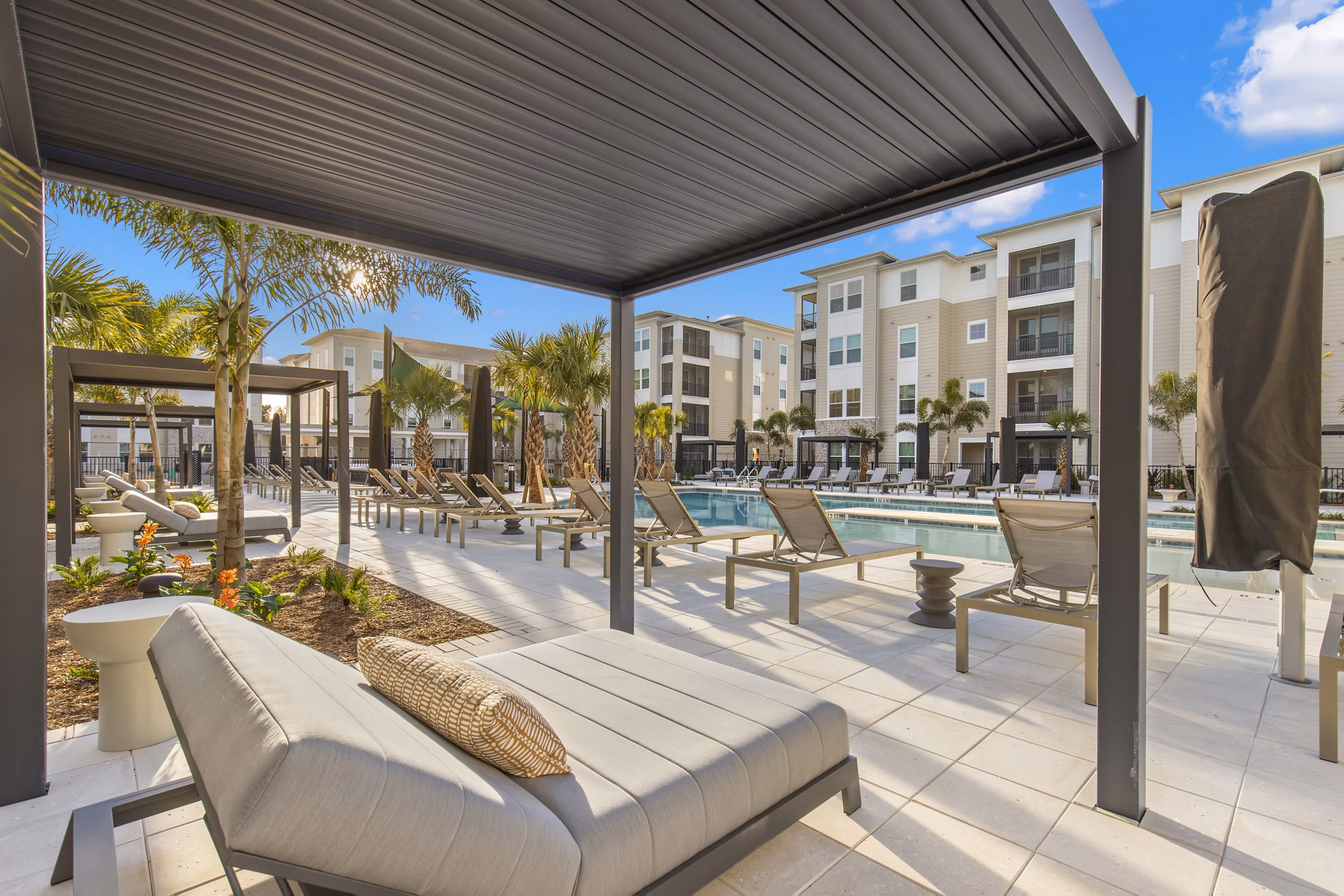 Milano Apartments: Serene courtyard with lush greenery and seating in a luxury community