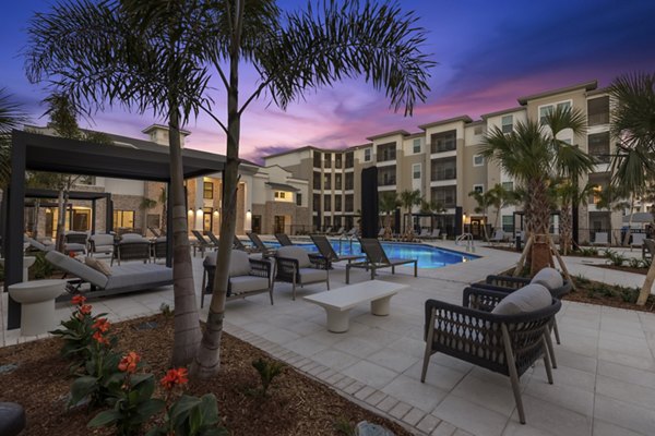 Milano Apartments: Tranquil courtyard with lush greenery and seating areas, offering a serene retreat within the community