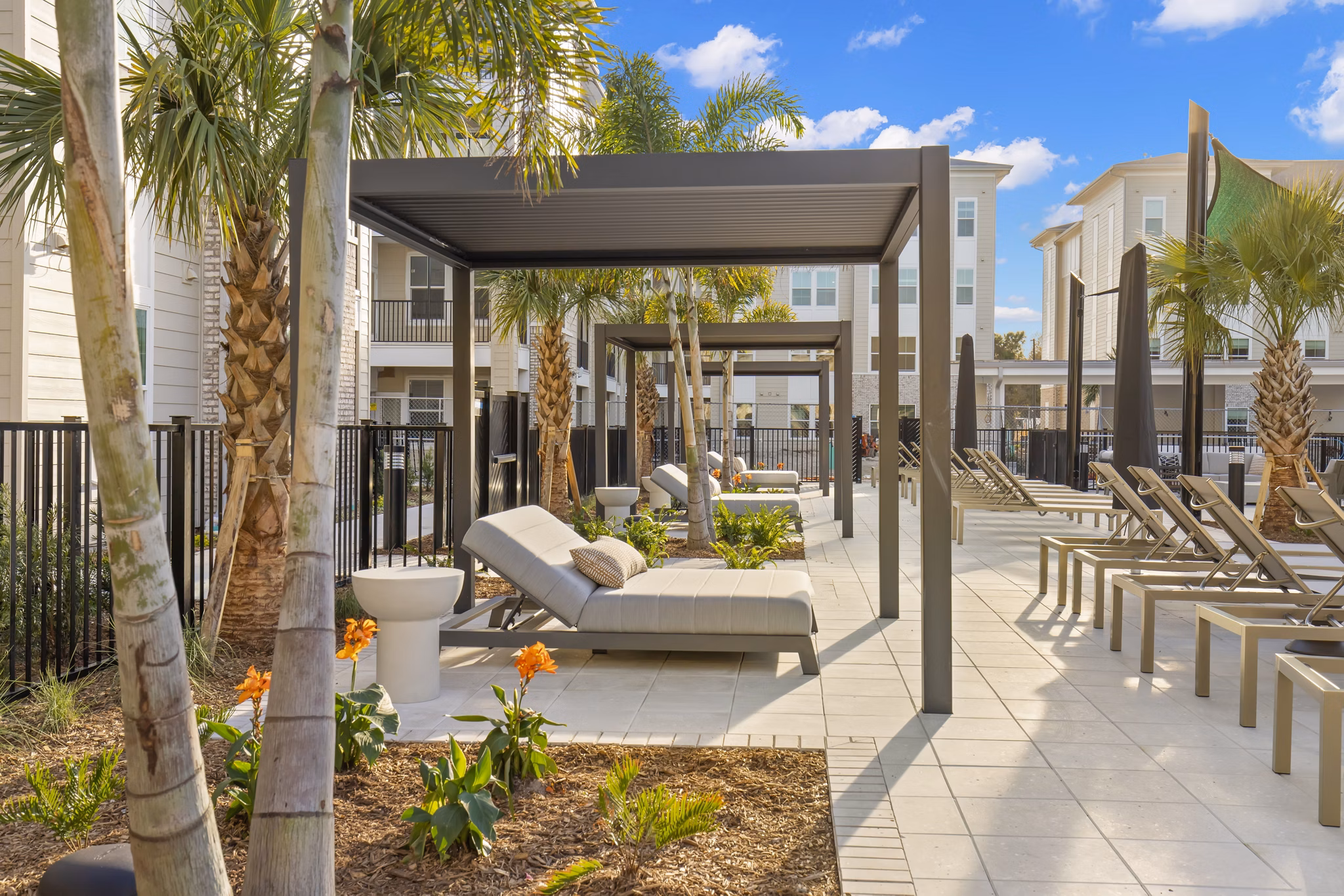 Tranquil courtyard featuring lush landscaping and seating area at Milano Apartments