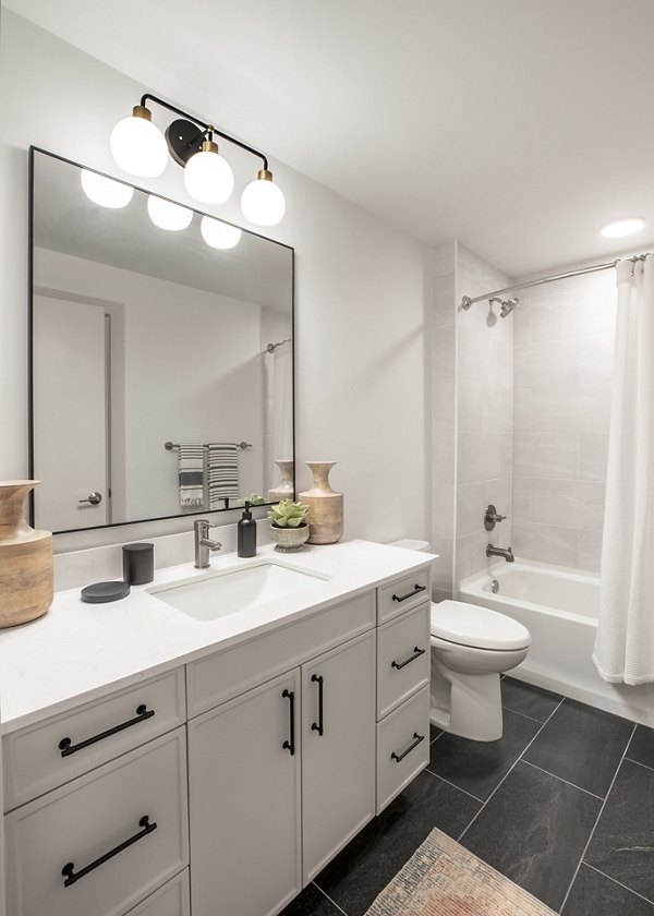 Elegant bathroom with modern fixtures at The Commodore Apartments, showcasing luxury living spaces in prime urban location