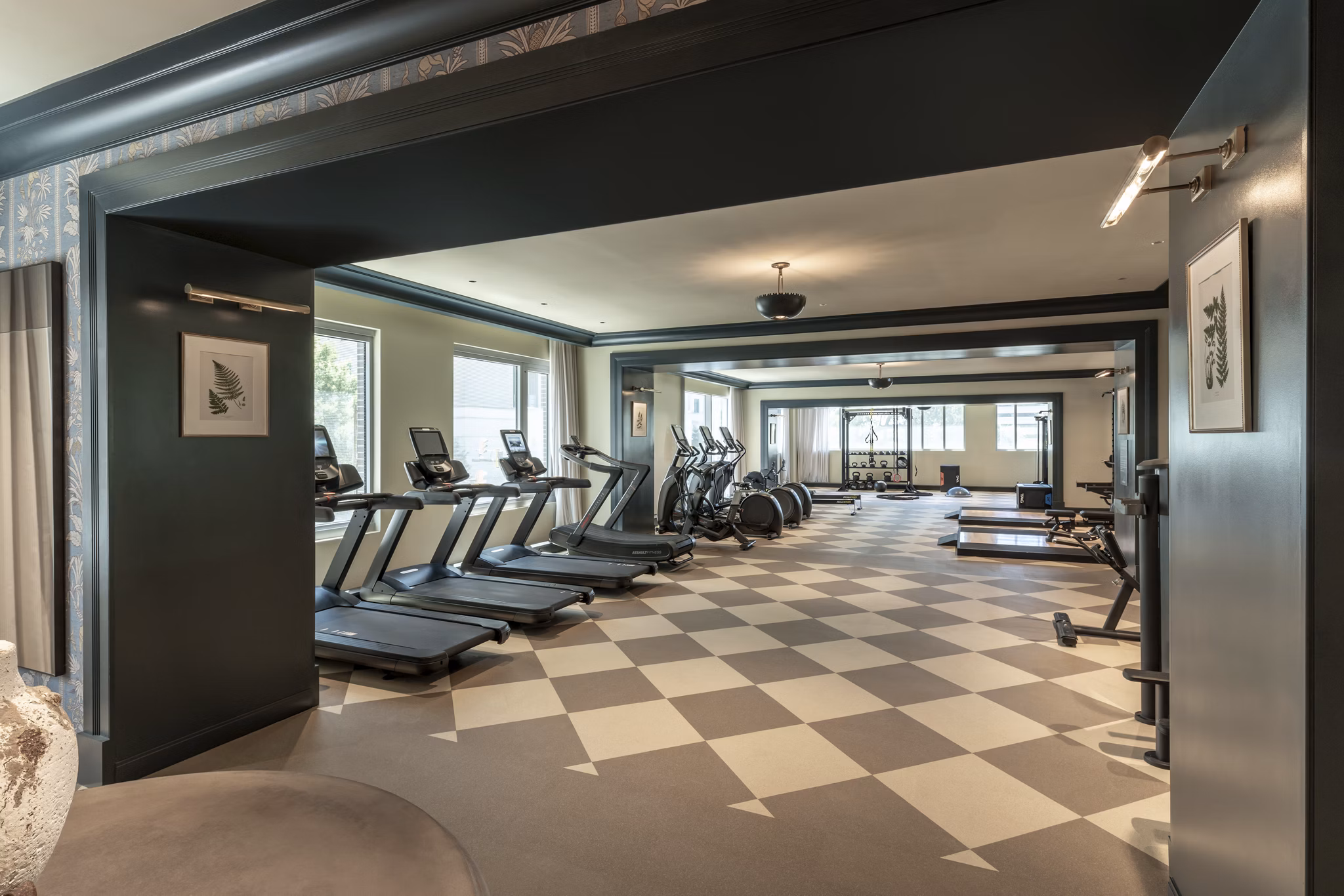 Modern fitness center with advanced equipment at The Commodore Apartments, offering residents a premium workout experience