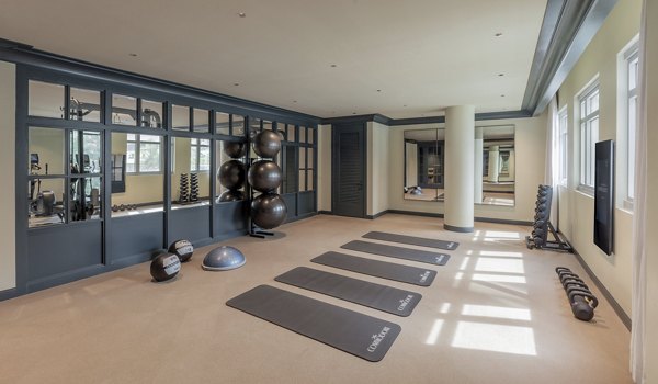 Modern fitness center at The Commodore Apartments featuring state-of-the-art equipment for residents' health and wellness