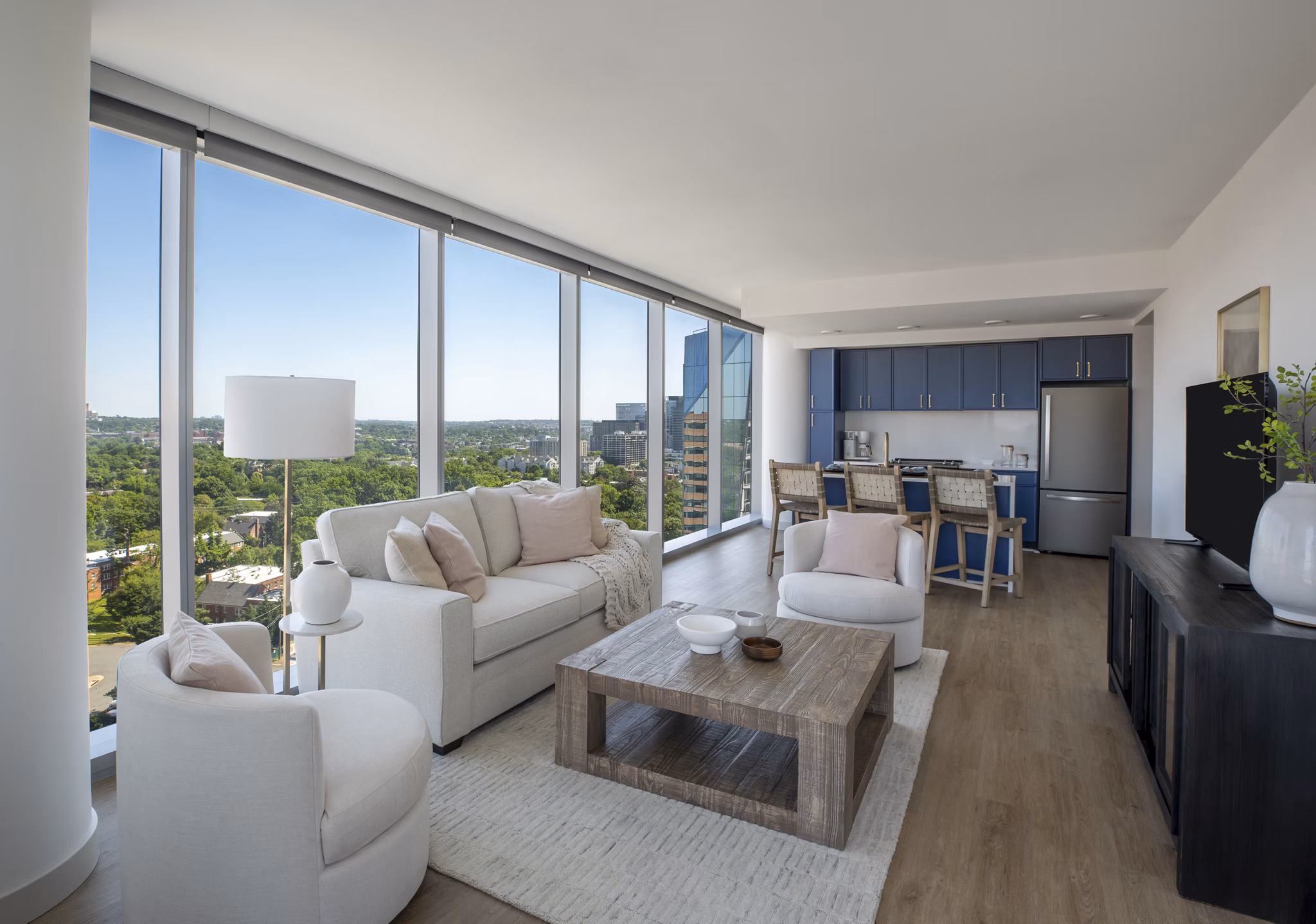 Living room with stylish decor and natural light at The Commodore Apartments