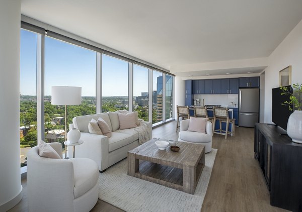 Living room with stylish decor and natural light at The Commodore Apartments