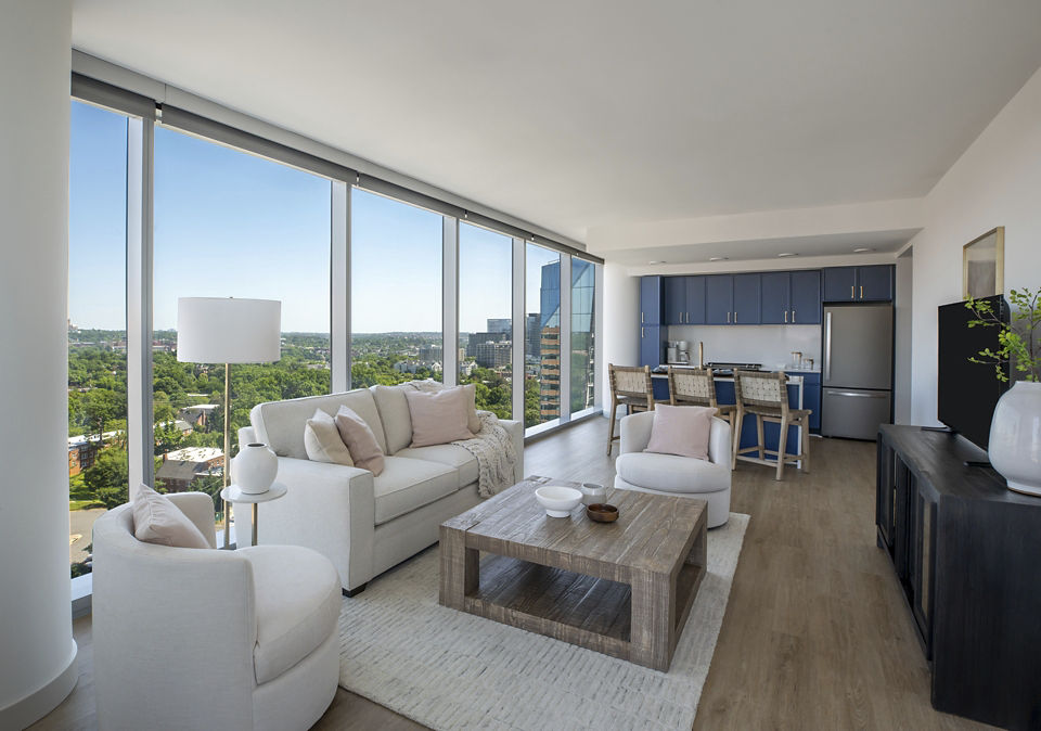 Living room with stylish decor and natural light at The Commodore Apartments