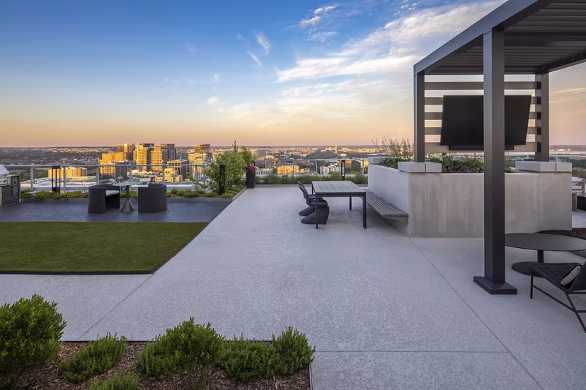 Expansive rooftop deck at The Commodore Apartments offering city skyline views