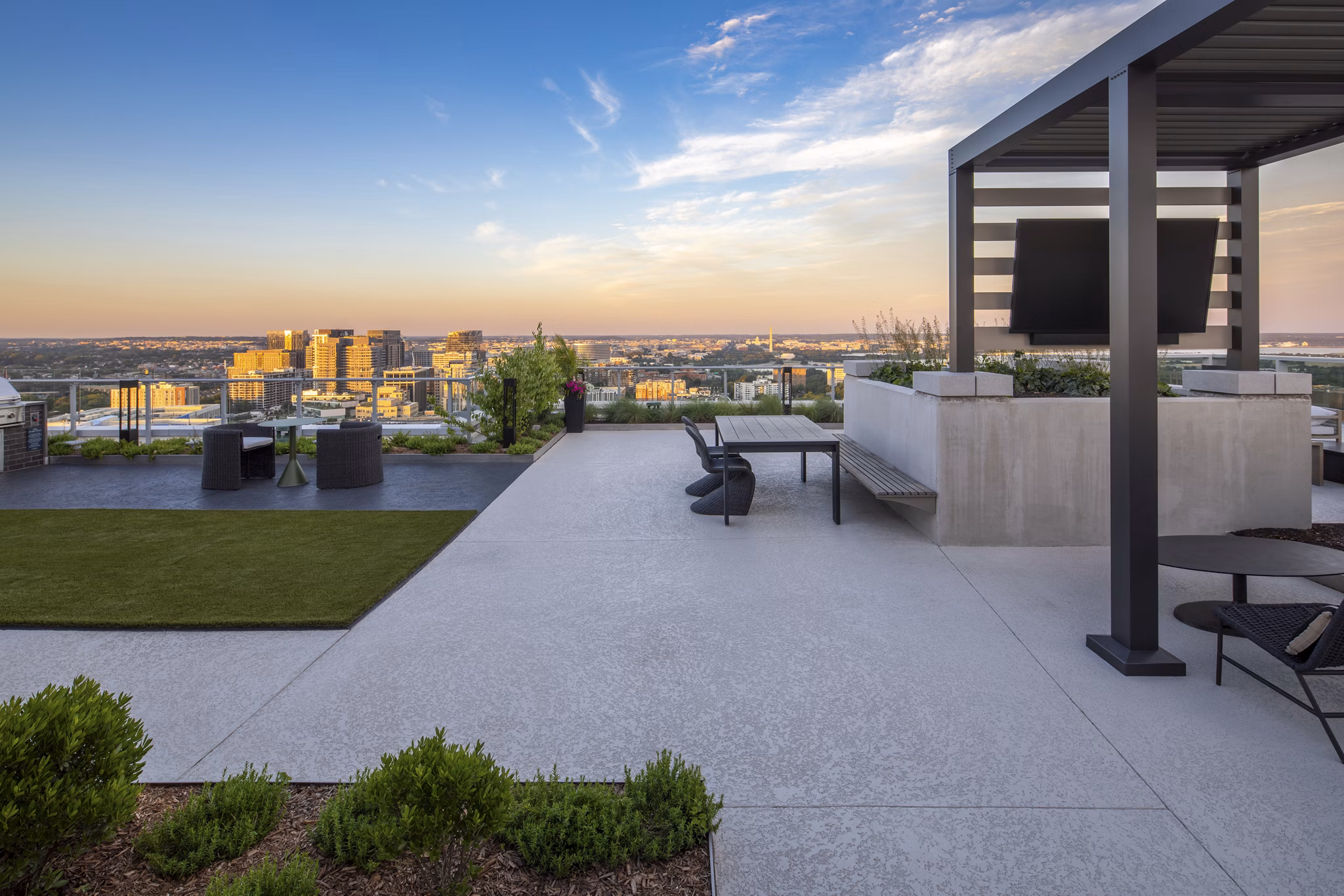 Expansive rooftop deck at The Commodore Apartments offering city skyline views