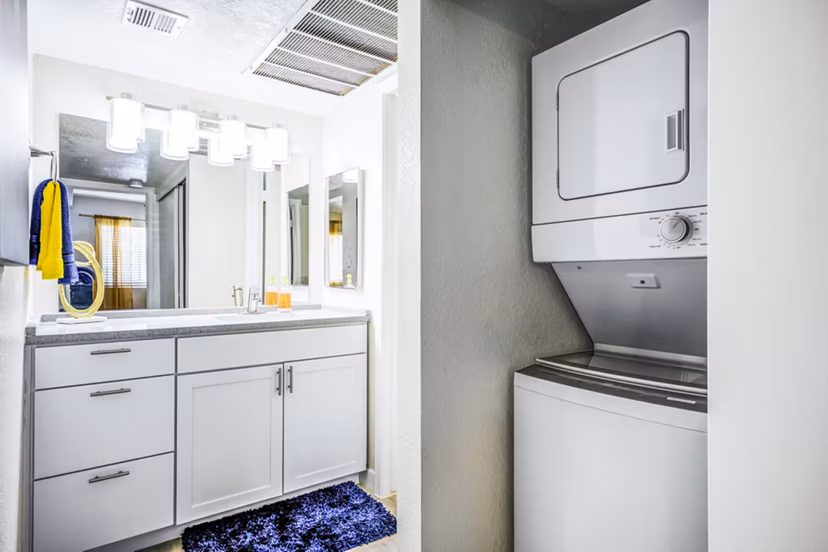 Modern laundry room with energy-efficient washers and dryers at Monterey Village Apartments