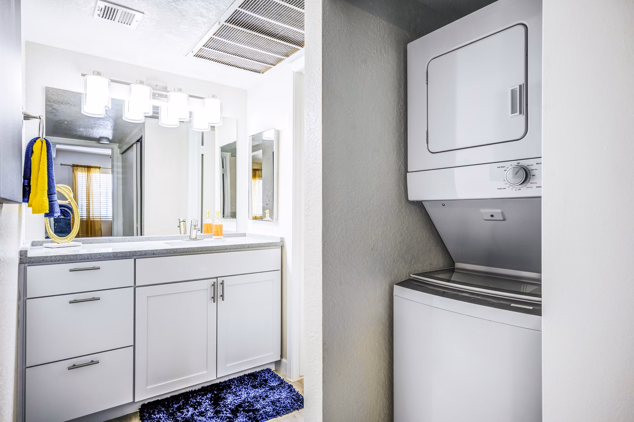 Modern laundry room with energy-efficient washers and dryers at Monterey Village Apartments