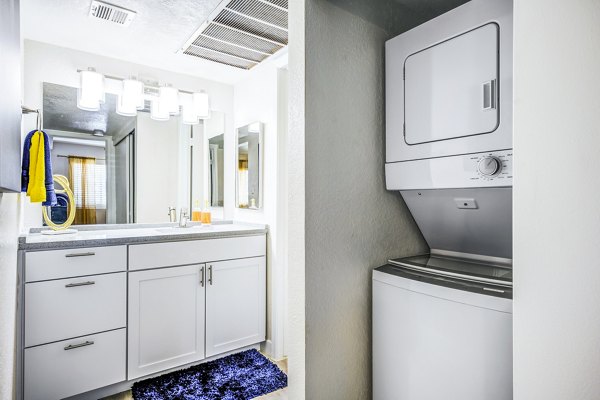 Modern laundry room with energy-efficient washers and dryers at Monterey Village Apartments