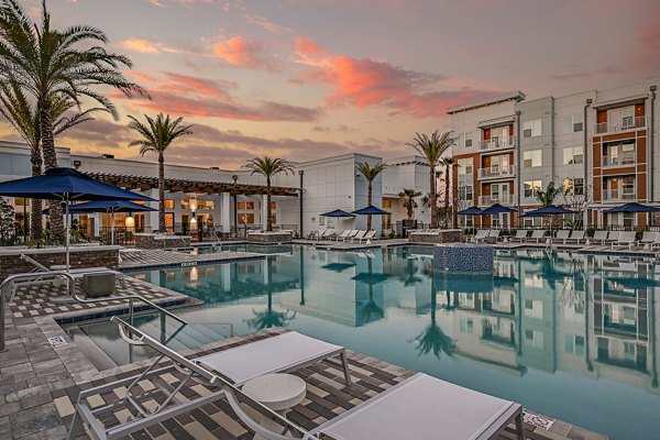 Aspire at Silverleaf Apartments: Modern pool with lounge chairs and greenery