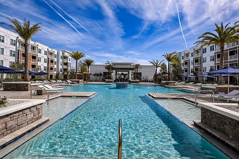 Resort-style pool with lounge chairs at Aspire at Silverleaf Apartments