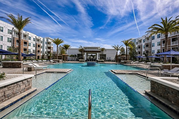 Resort-style pool with lounge chairs at Aspire at Silverleaf Apartments