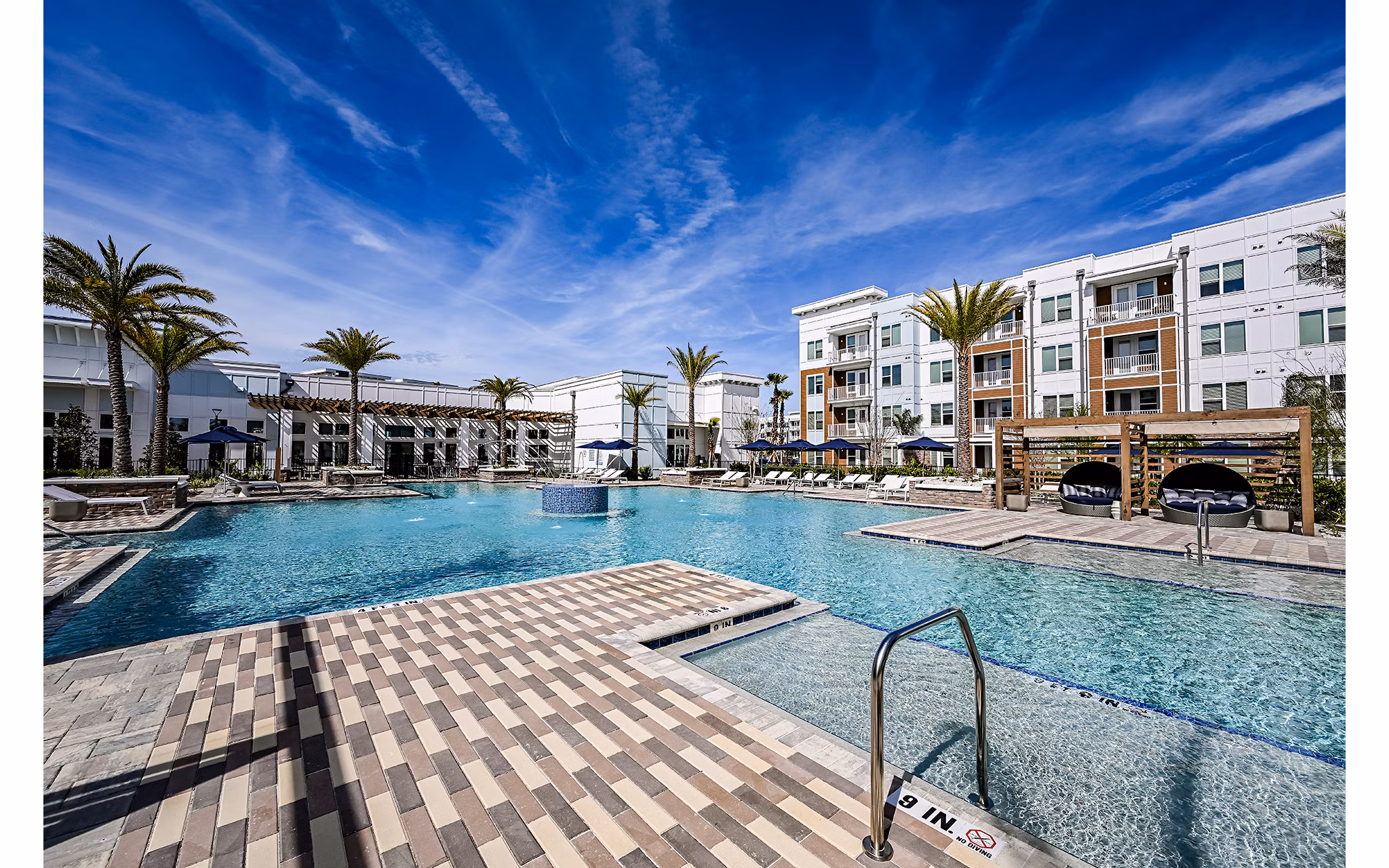 Aspire at Silverleaf Apartments: Luxurious outdoor pool with lounge area adjacent to main building
