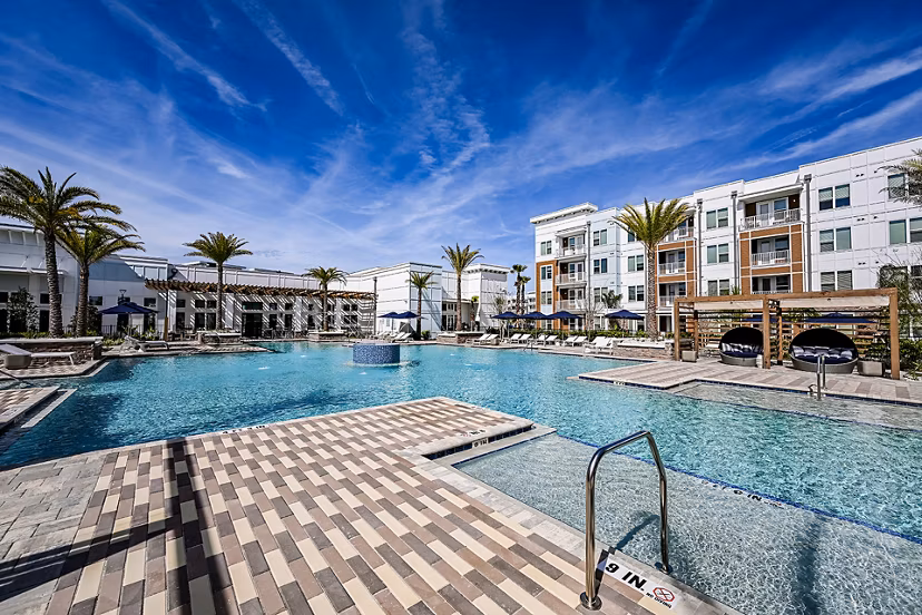 Aspire at Silverleaf Apartments: Luxurious outdoor pool with lounge area adjacent to main building