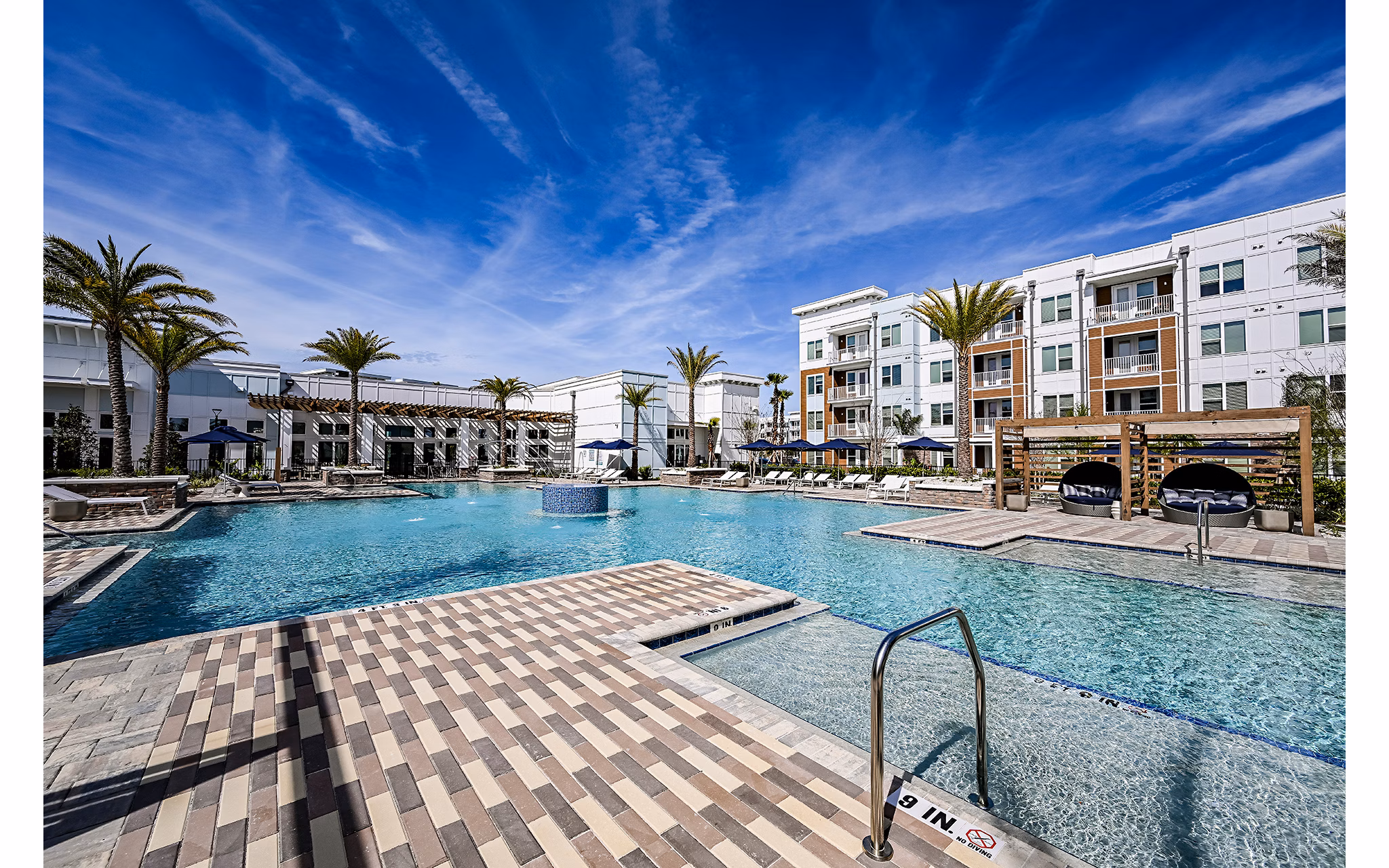 Aspire at Silverleaf Apartments: Luxurious outdoor pool with lounge area adjacent to main building