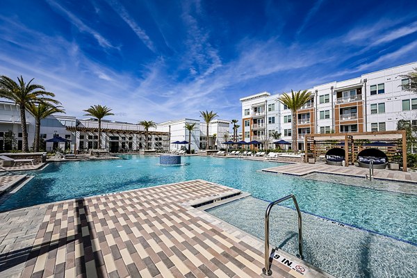 Aspire at Silverleaf Apartments: Luxurious outdoor pool with lounge area adjacent to main building