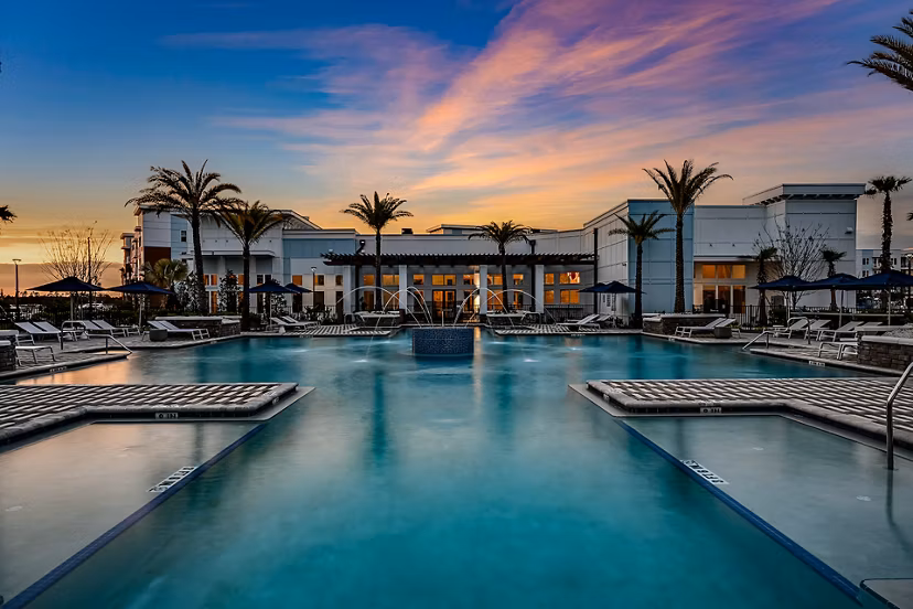 Resort-style pool with lounge chairs at Aspire at Silverleaf Apartments, offering luxury living in a serene setting