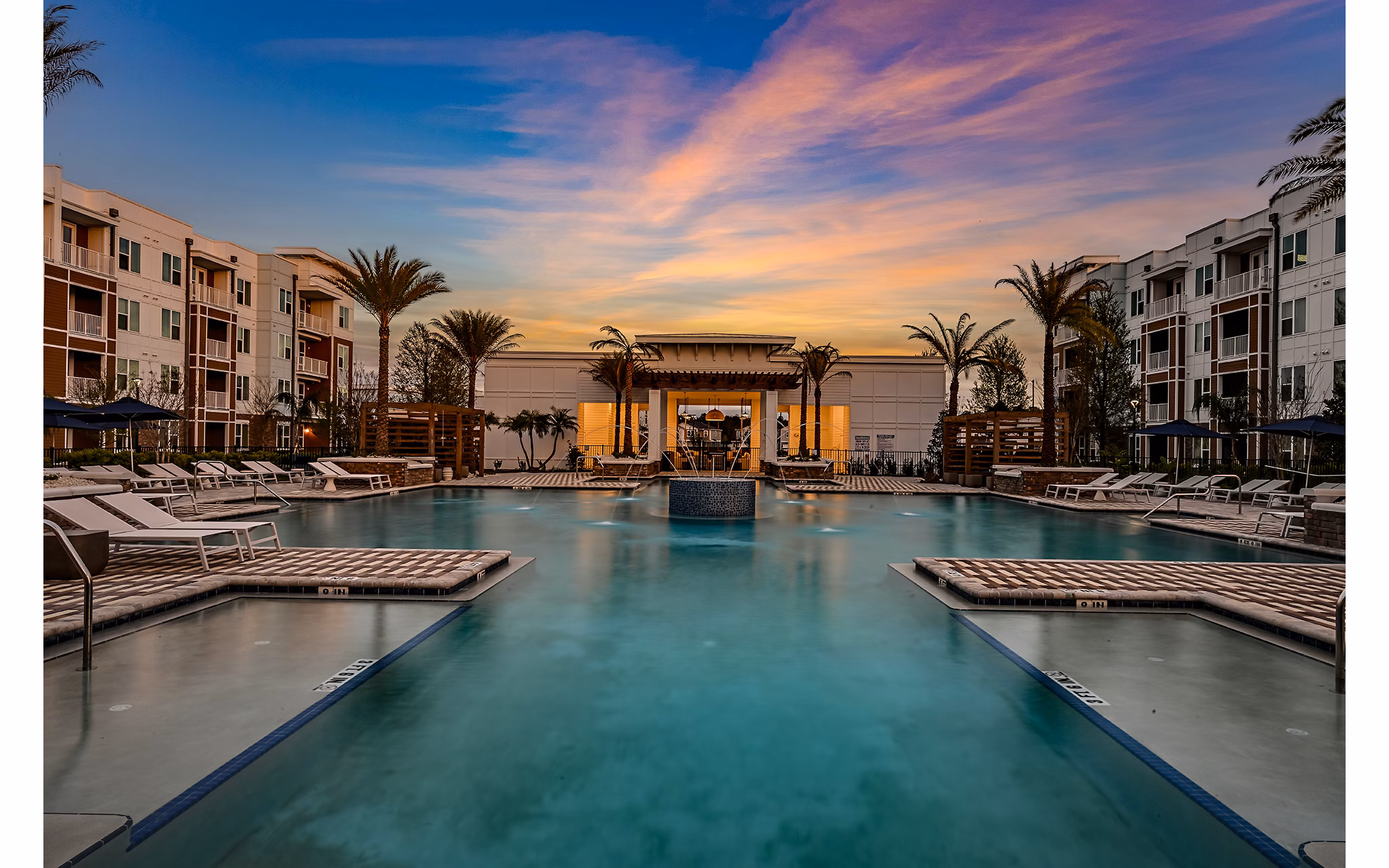 Aspire at Silverleaf: Luxury pool with lounge chairs for relaxation, perfect for residents seeking upscale apartment living