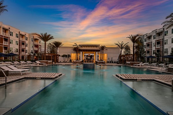 Aspire at Silverleaf: Luxury pool with lounge chairs for relaxation, perfect for residents seeking upscale apartment living