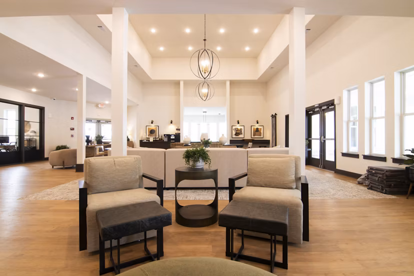 Sage North Apartments: Elegant clubhouse with modern furnishings and ample seating, ideal for social gatherings and events in premium amenities