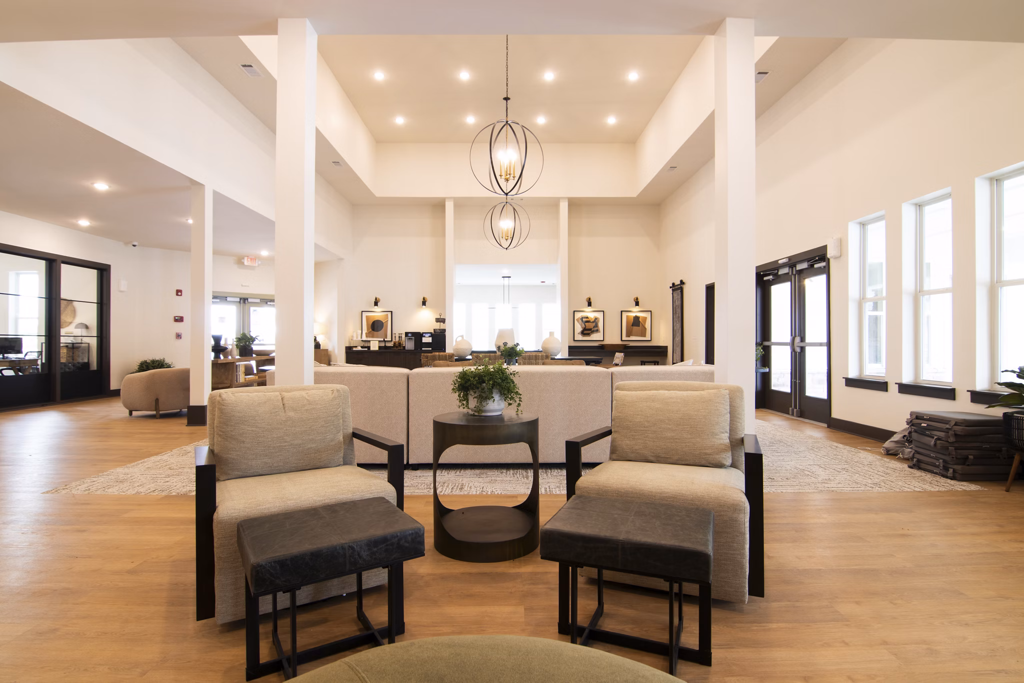 Sage North Apartments: Elegant clubhouse with modern furnishings and ample seating, ideal for social gatherings and events in premium amenities