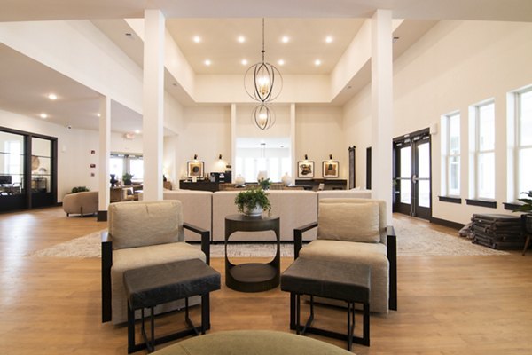 Sage North Apartments: Elegant clubhouse with modern furnishings and ample seating, ideal for social gatherings and events in premium amenities