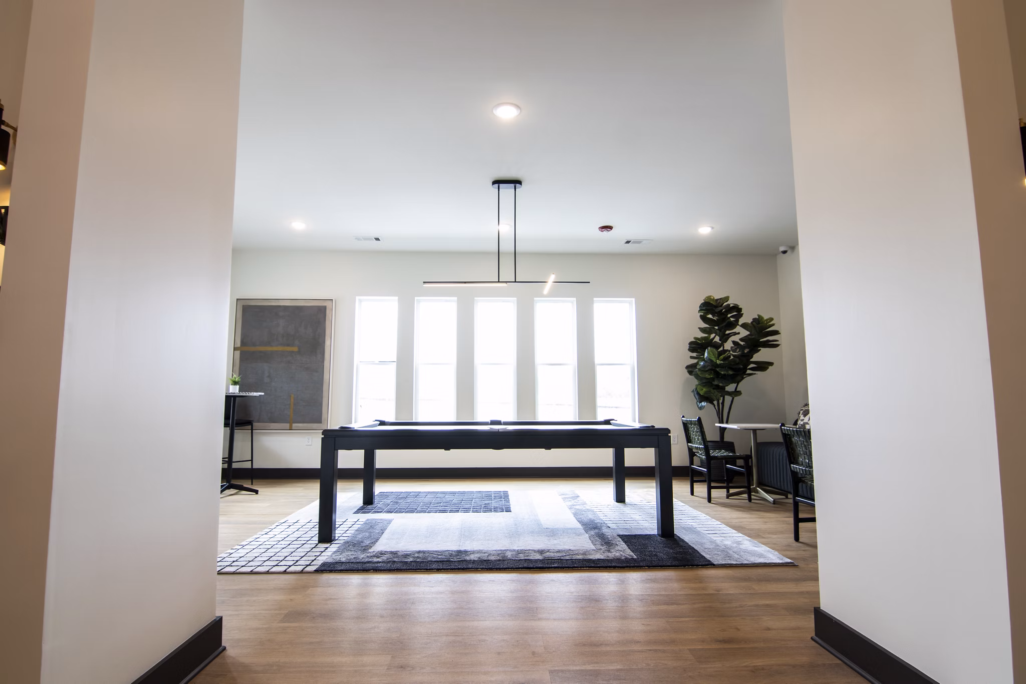 Clubhouse offering modern lounge seating and entertainment amenities at Sage North Apartments