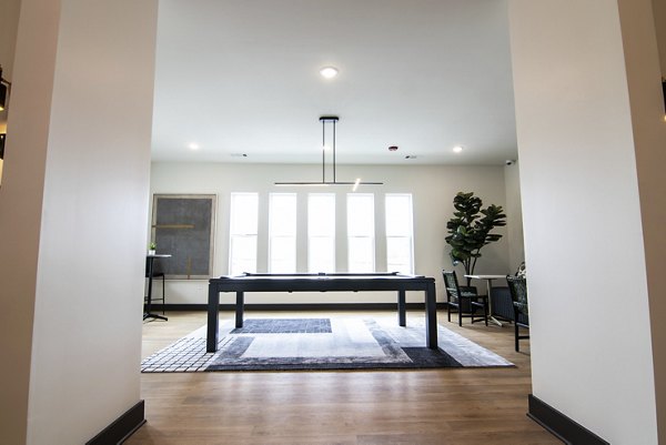 Clubhouse offering modern lounge seating and entertainment amenities at Sage North Apartments