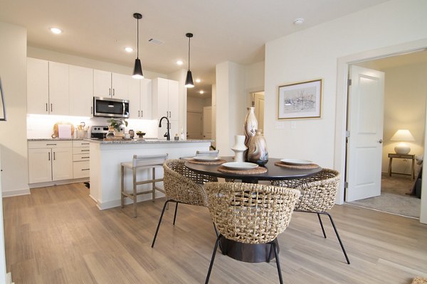 Dining area with modern decor and elegant lighting at Sage North Apartments' luxury residence