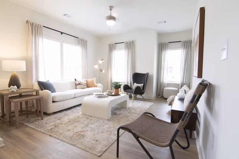 Modern living room with stylish decor at Sage North Apartments, featuring cozy seating and natural light