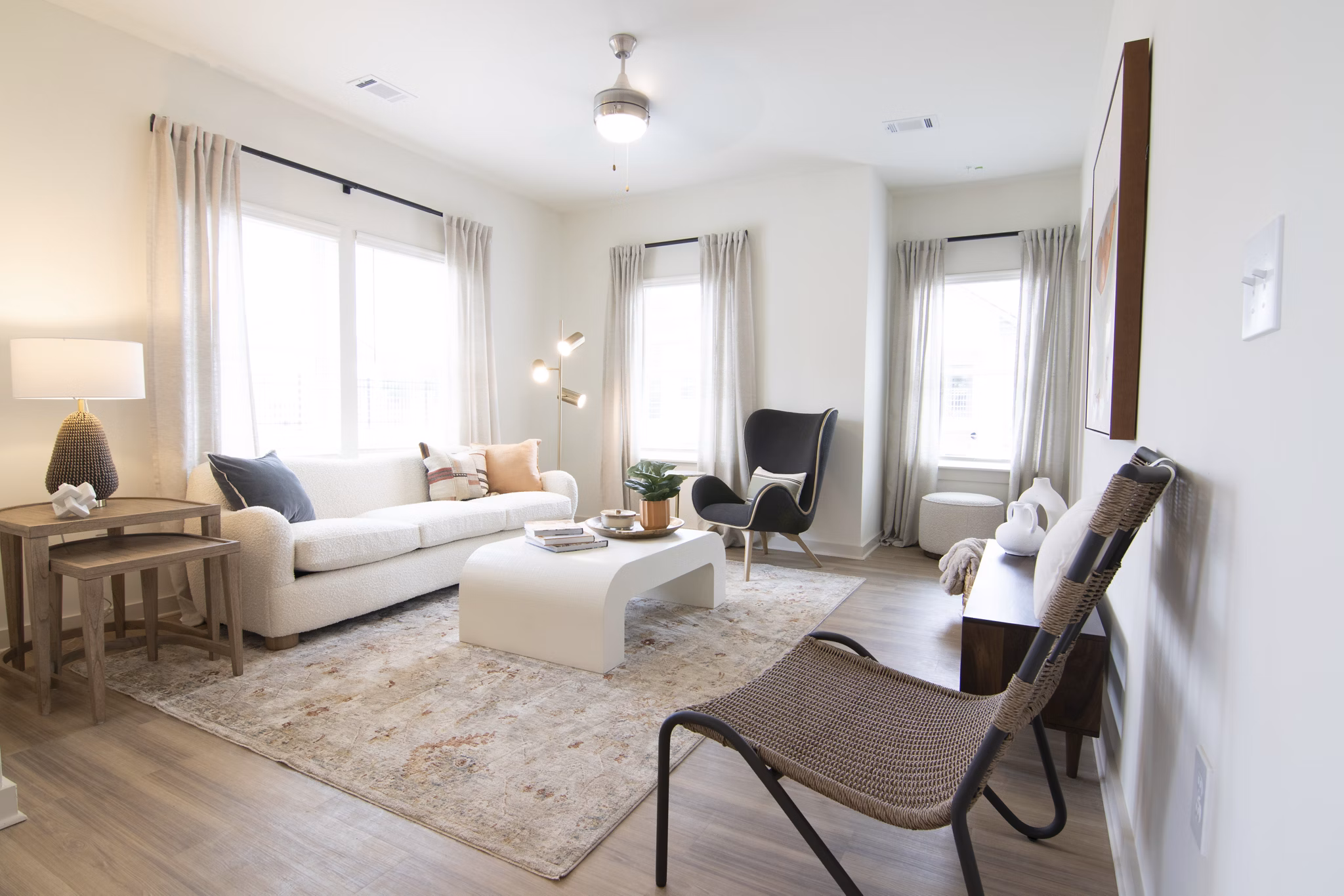 Modern living room with stylish decor at Sage North Apartments, featuring cozy seating and natural light