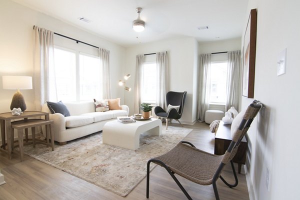 Modern living room with stylish decor at Sage North Apartments, featuring cozy seating and natural light