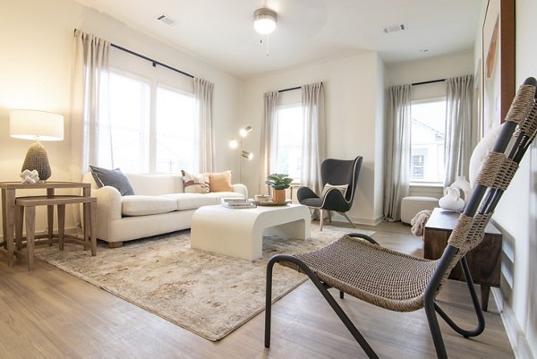 Contemporary living room with plush seating in Sage North Apartments