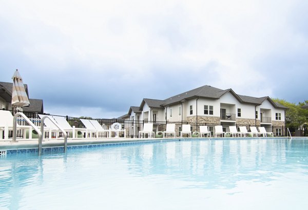 Resort-style pool with lounge chairs at Sage North Apartments offering luxury living