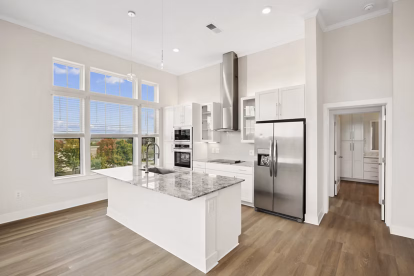 Modern kitchen featuring stainless steel appliances and granite countertops at 3500 West View Apartments