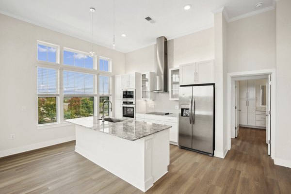 Modern kitchen featuring stainless steel appliances and granite countertops at 3500 West View Apartments