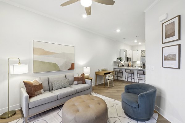 Modern living room featuring plush seating and large windows in 3500 West View Apartments