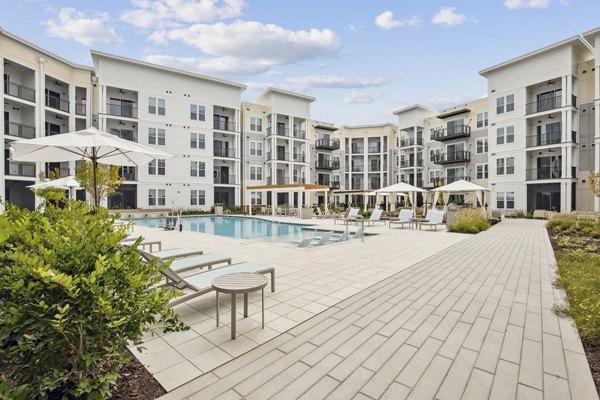 Outdoor swimming pool at 3500 West View Apartments with luxury lounge chairs and scenic views