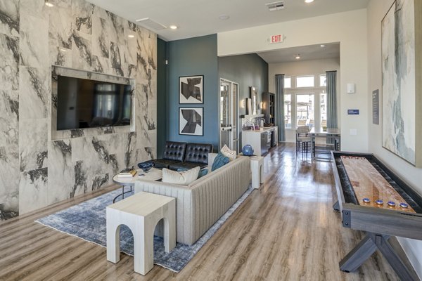 Clubhouse featuring modern decor and communal workspace at Prose Prominence Apartments