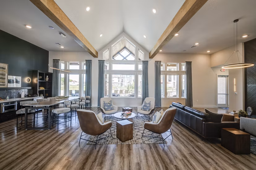 Clubhouse with modern seating and game tables at Prose Prominence Apartments