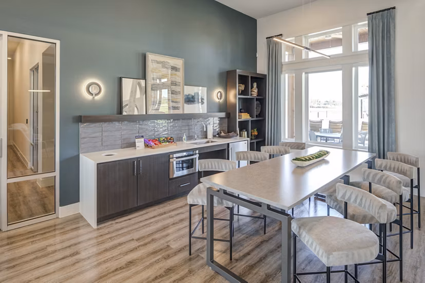 Clubhouse with modern seating and large windows at Prose Prominence Apartments