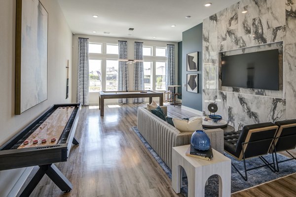 Game room with billiards and lounge seating at Prose Prominence Apartments