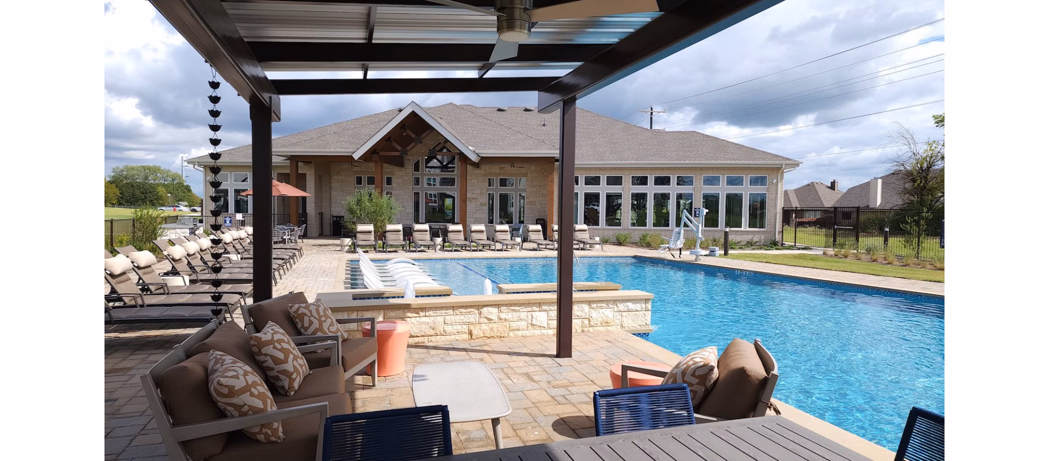 Outdoor pool with sundeck at Prose Prominence Apartments, offering luxury relaxation and leisure