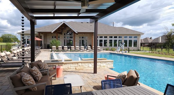 Outdoor pool with sundeck at Prose Prominence Apartments, offering luxury relaxation and leisure