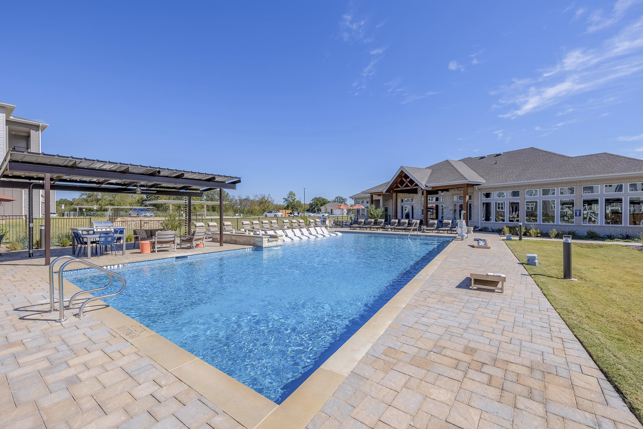 Modern pool with lounge chairs at Prose Prominence Apartments, a luxury community offering premium amenities for residents